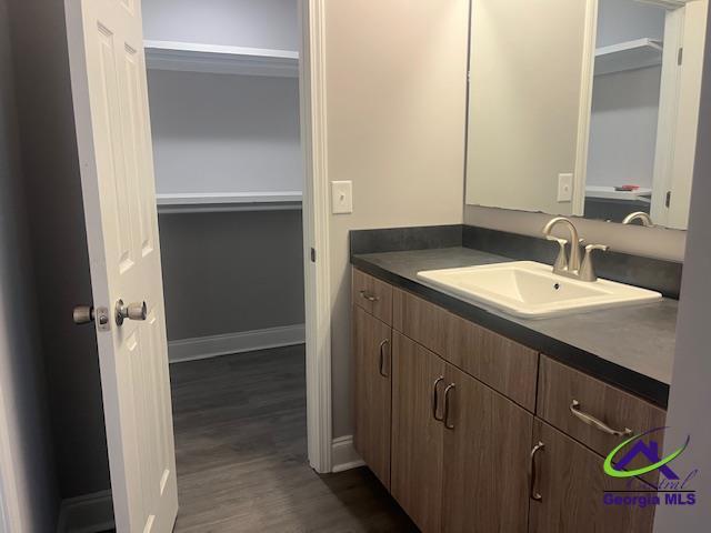 324 Jefferson Park Dr, Macon, GA 31220 - bathroom featuring wood finished floors, vanity, and baseboards