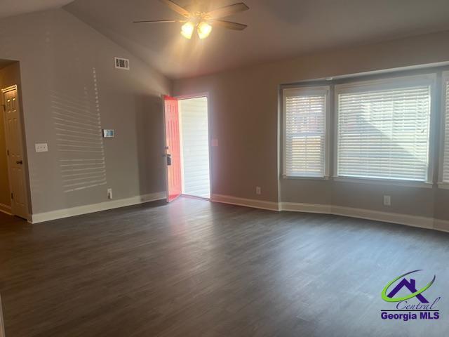 324 Jefferson Park Dr, Macon, GA 31220 - unfurnished room featuring lofted ceiling, ceiling fan, dark wood-style flooring, visible vents, and baseboards
