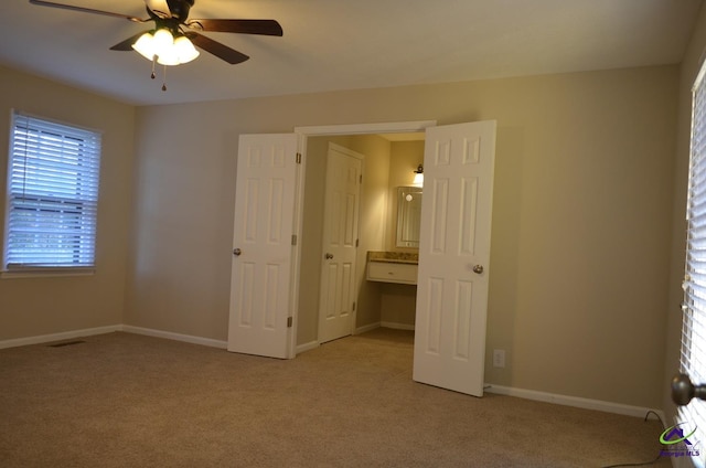 unfurnished bedroom featuring light colored carpet, visible vents, and baseboards