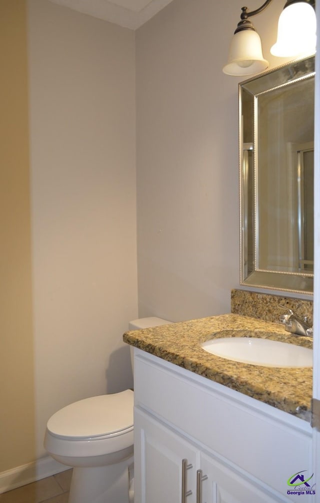 full bath featuring toilet, tile patterned flooring, vanity, and a shower with door