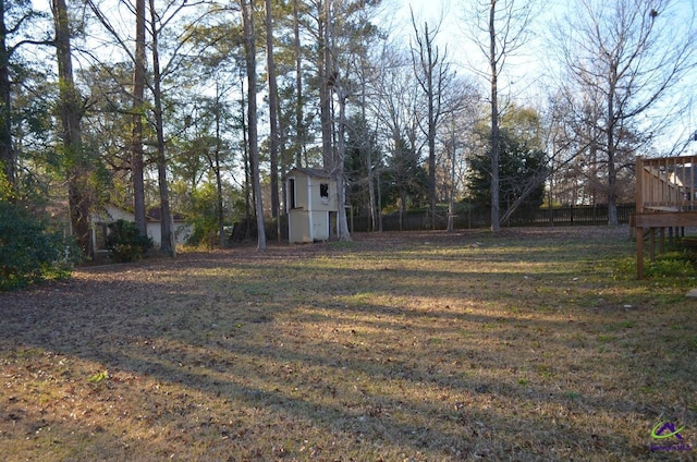 view of yard featuring fence and a wooden deck