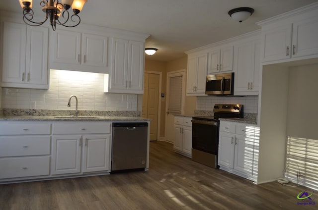 kitchen featuring stainless steel appliances, a sink, and white cabinets