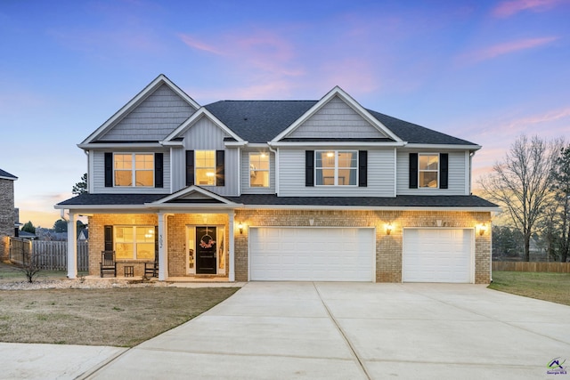 view of front of property with concrete driveway, brick siding, an attached garage, and fence