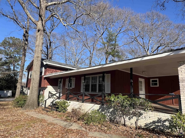 view of front of property with covered porch and brick siding