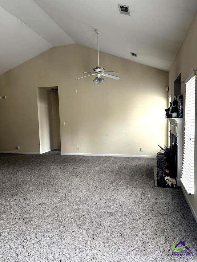 unfurnished living room featuring lofted ceiling, a fireplace, carpet flooring, and visible vents