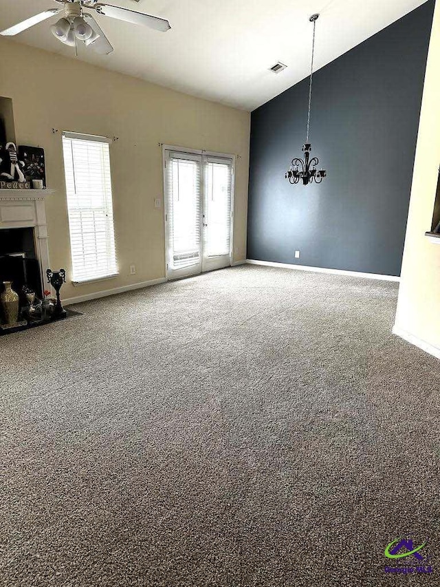 unfurnished living room featuring high vaulted ceiling, a fireplace, baseboards, and ceiling fan with notable chandelier