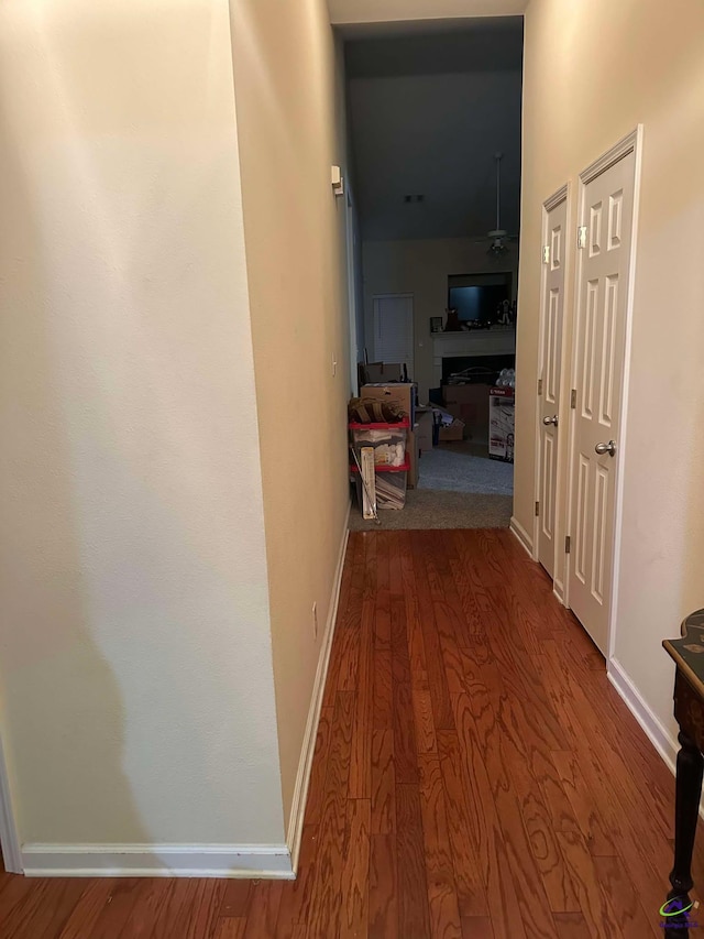 hall featuring wood finished floors and baseboards