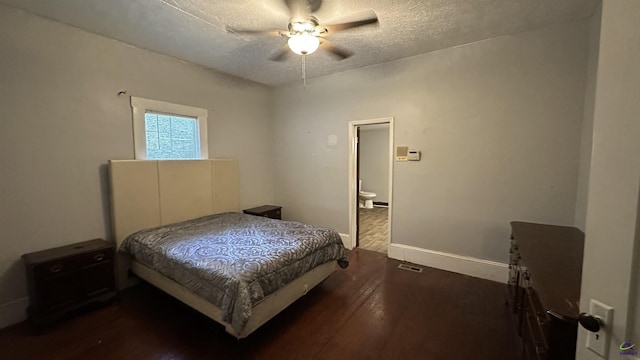 bedroom with dark wood-style flooring, connected bathroom, ceiling fan, a textured ceiling, and baseboards