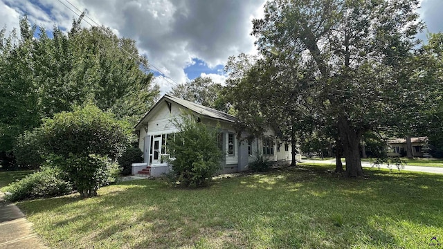 view of home's exterior with crawl space and a yard