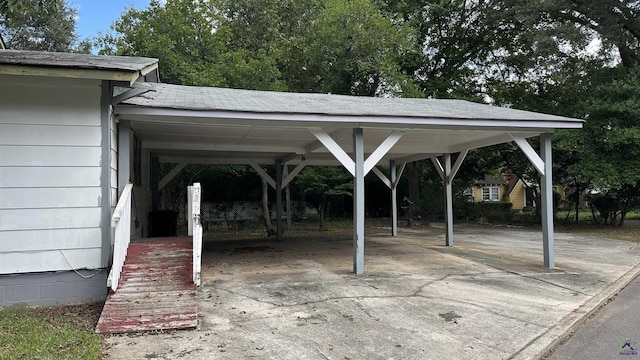 view of car parking featuring driveway and an attached carport