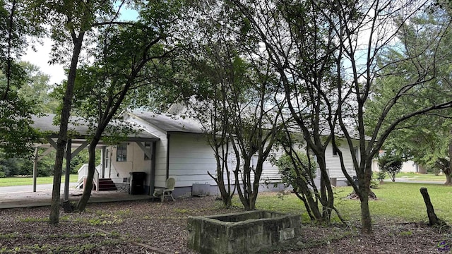 view of side of home with a yard