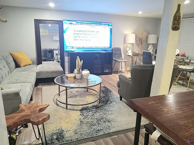 living area with light wood-style flooring and recessed lighting