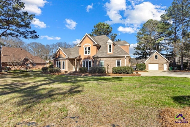 view of front of property with an outbuilding, brick siding, a detached garage, roof with shingles, and a front lawn