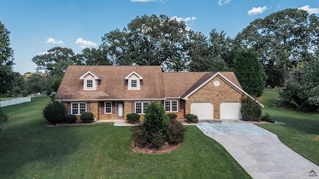 cape cod-style house featuring brick siding, driveway, and a front lawn