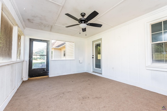 unfurnished sunroom with a ceiling fan