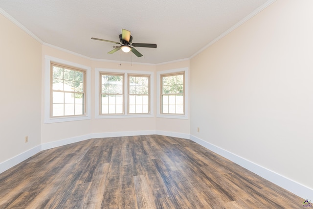 spare room featuring a ceiling fan, baseboards, dark wood finished floors, and crown molding