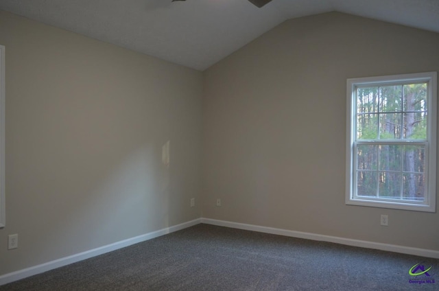 unfurnished room with lofted ceiling, baseboards, and carpet flooring