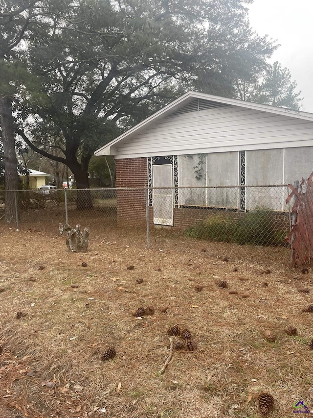 exterior space with brick siding and fence