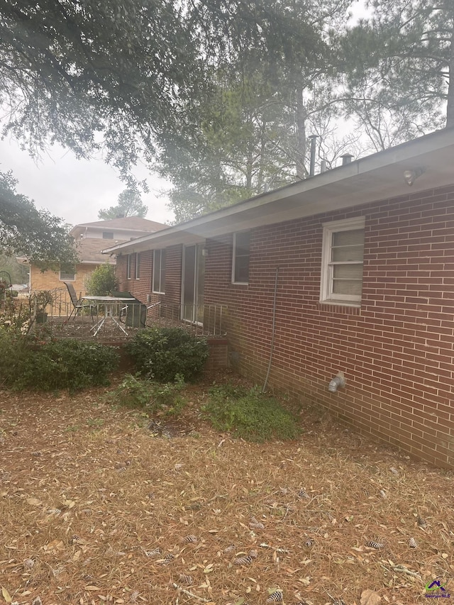 view of side of home featuring brick siding