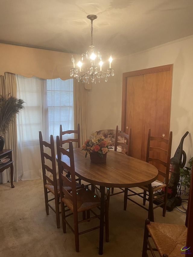 dining room featuring carpet and a notable chandelier