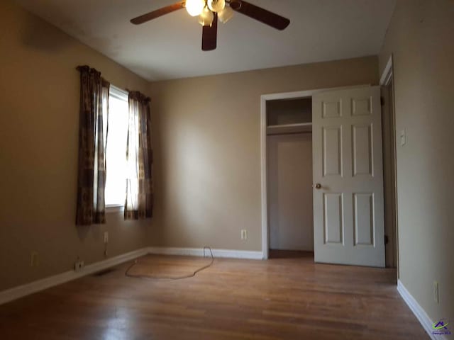 3271 Commodore Dr, Macon, GA 31211 - unfurnished bedroom featuring a closet, wood finished floors, baseboards, and a ceiling fan
