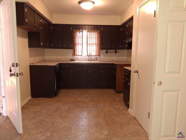 3271 Commodore Dr, Macon, GA 31211 - kitchen with light floors, under cabinet range hood, a sink, dark brown cabinetry, and light countertops