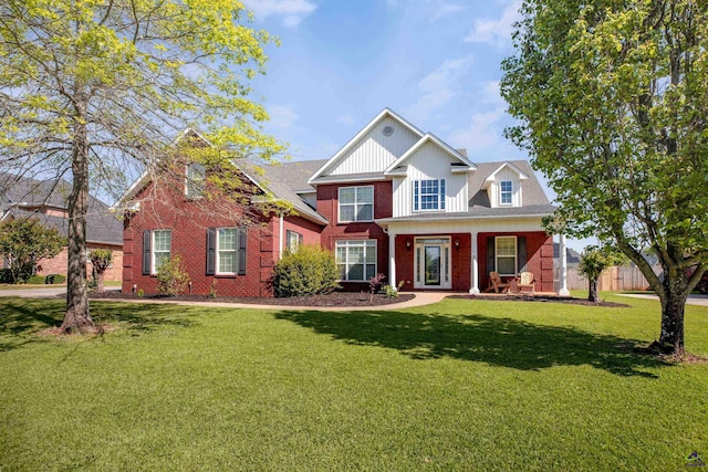 view of front facade featuring a front yard, fence, and brick siding