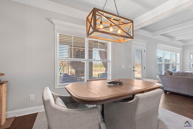 dining area with beam ceiling, crown molding, wood finished floors, a chandelier, and baseboards