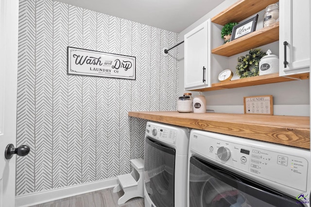 laundry area featuring washing machine and dryer and cabinet space