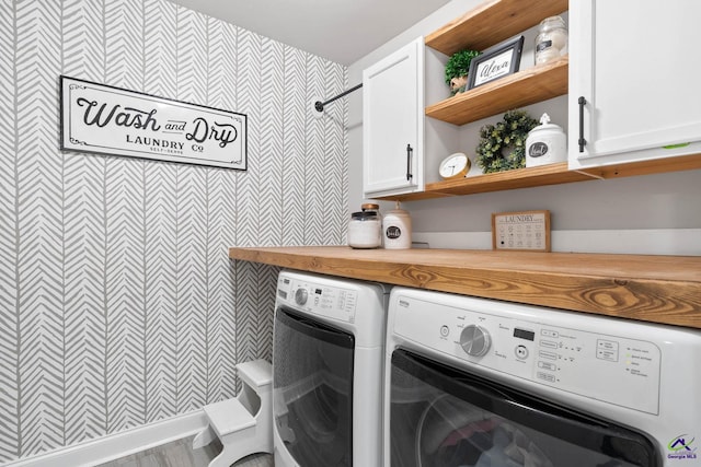 laundry room with washer and dryer and cabinet space