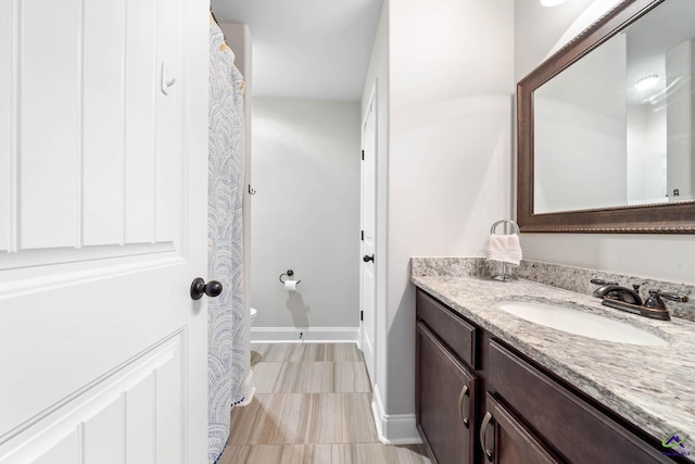 bathroom featuring vanity and baseboards