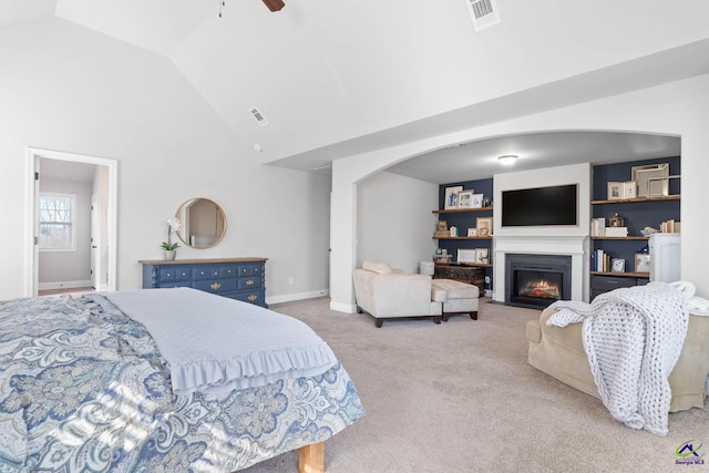 carpeted bedroom featuring arched walkways, high vaulted ceiling, a fireplace with flush hearth, visible vents, and baseboards