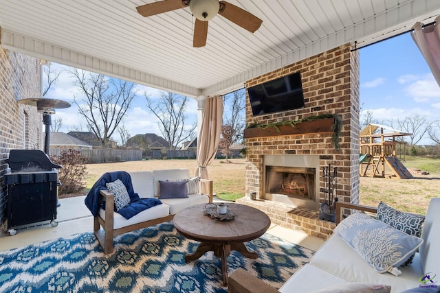 view of patio featuring an outdoor living space with a fireplace, a grill, fence, and a ceiling fan