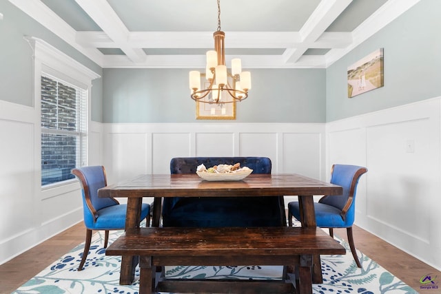 dining room with coffered ceiling, beam ceiling, and wood finished floors