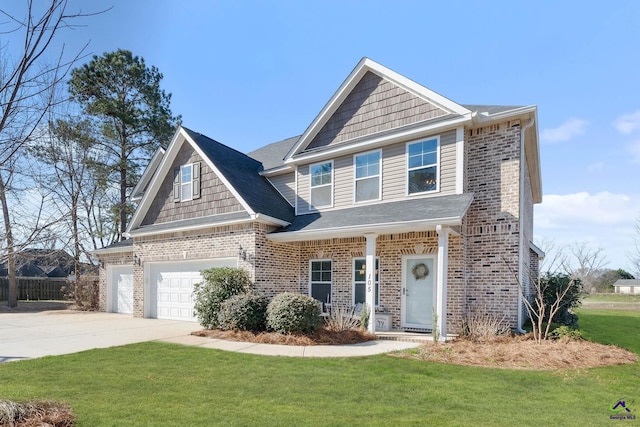 view of front of house featuring a front yard, brick siding, and driveway