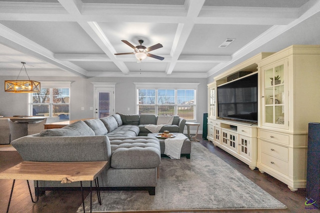 living room featuring dark wood-style flooring, visible vents, and beamed ceiling