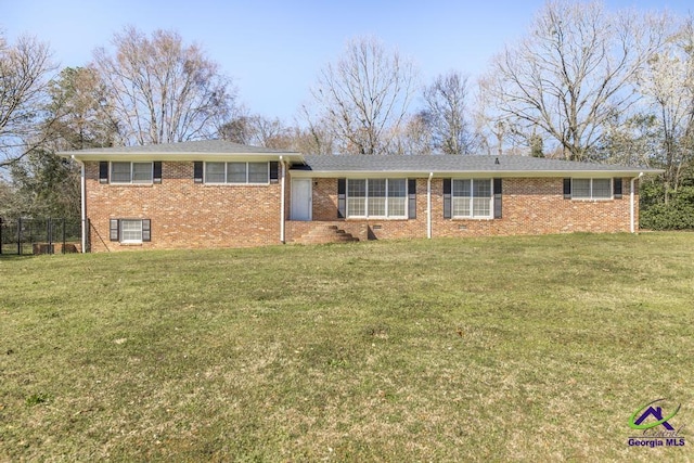 view of front of house with brick siding and a front yard