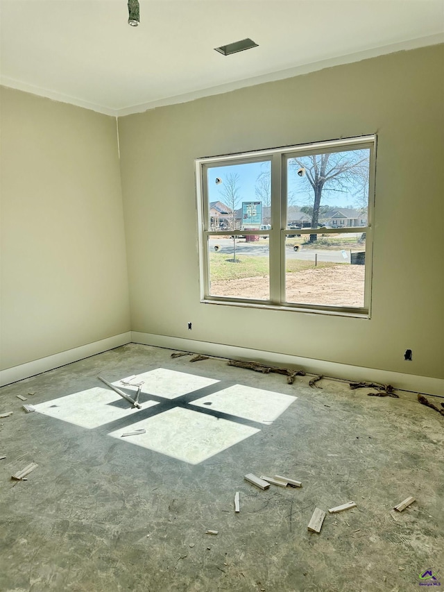 empty room with plenty of natural light and baseboards