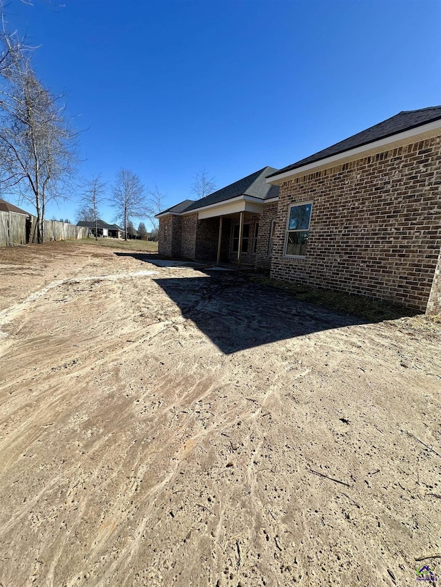 back of house with brick siding