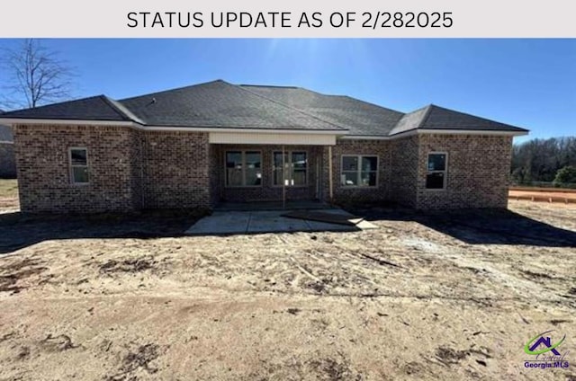 rear view of house with a patio and brick siding