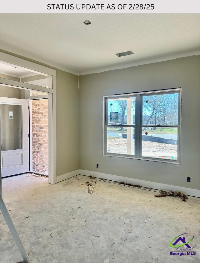 102 Reedy Ct, Perry, GA 31069 - spare room featuring plenty of natural light, a textured ceiling, and baseboards