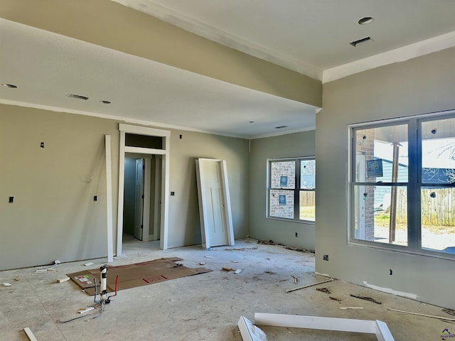 unfurnished room with visible vents and crown molding