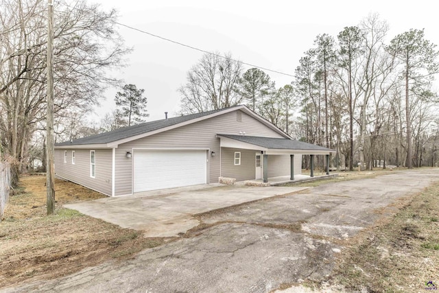 view of front facade with concrete driveway, covered porch, and an attached garage