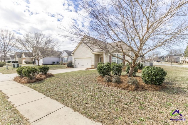 view of front of home with concrete driveway, a front lawn, and an attached garage