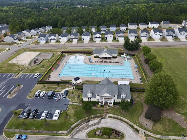 drone / aerial view with a forest view and a residential view