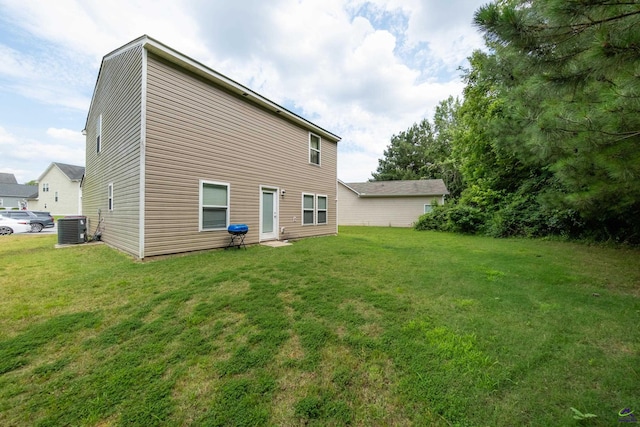 rear view of house featuring a yard and cooling unit