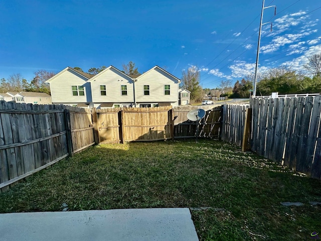 view of yard with a fenced backyard