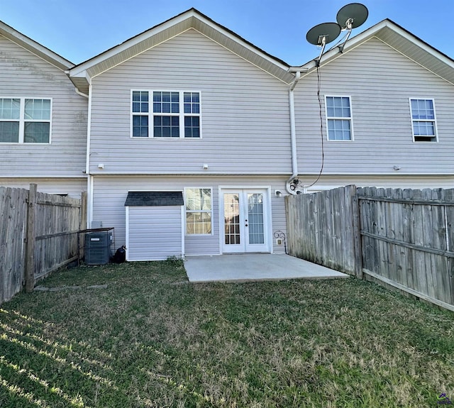 back of property featuring a patio, a lawn, a fenced backyard, and central air condition unit