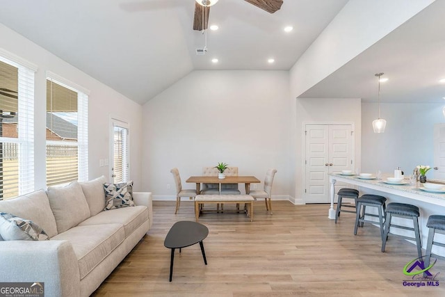 422 Chelsea Leigh Ave, Bonaire, GA 31005 - living area featuring visible vents, baseboards, a ceiling fan, light wood-style floors, and vaulted ceiling