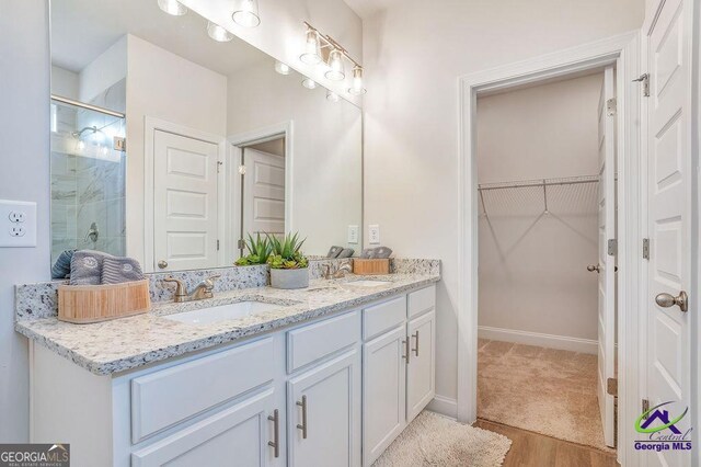 422 Chelsea Leigh Ave, Bonaire, GA 31005 - full bath with a shower stall, double vanity, a sink, and a walk in closet